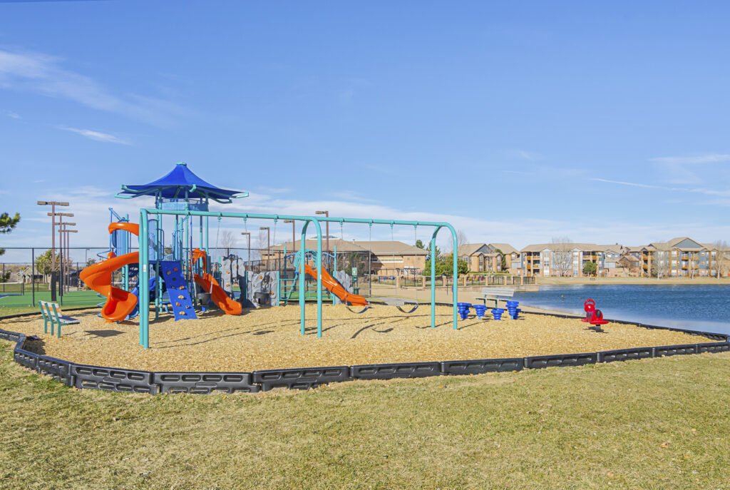 Children's playground by the water with slides and swings