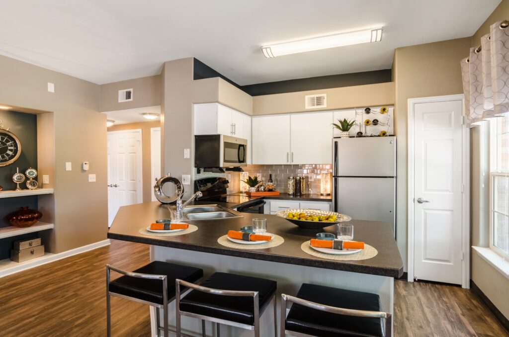 Kitchen with granite counters, stainless steel appliances, and tile backsplash