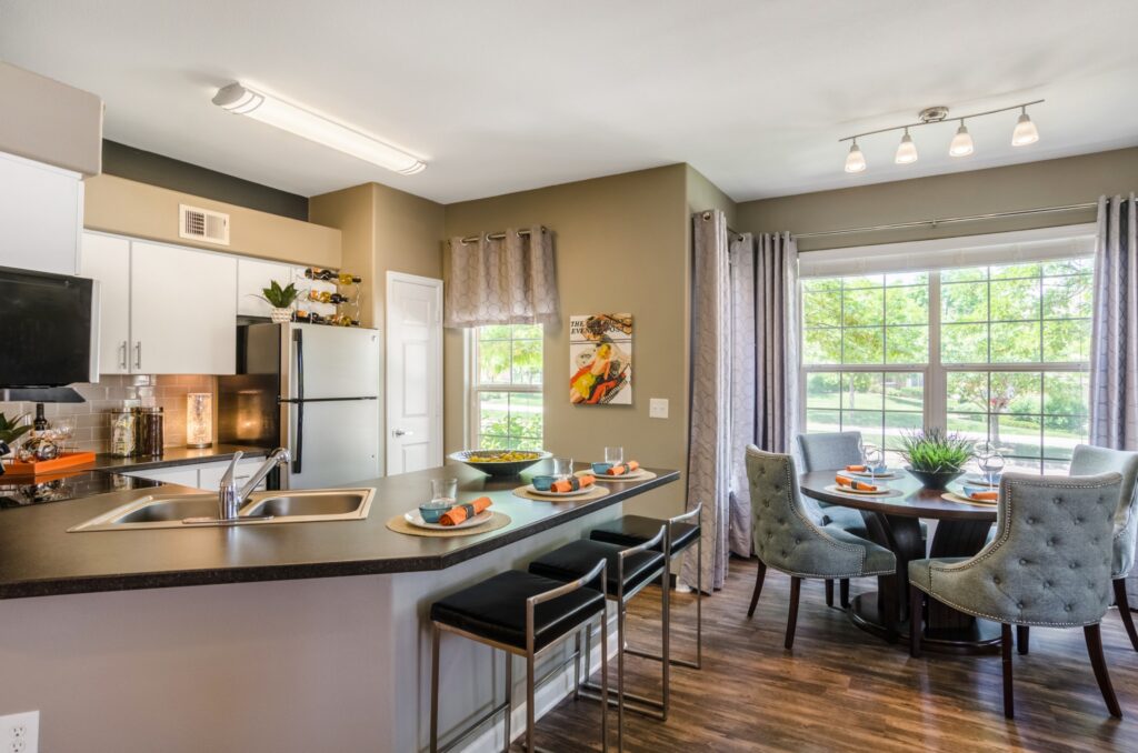 Kitchen with granite counters, stainless steel appliances, and tile backsplash